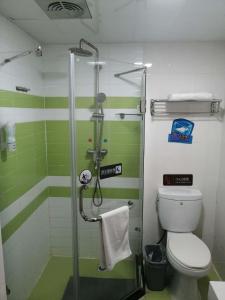 a bathroom with a shower and a toilet at 7Days Premium Qingdao Xianggang Middle Road Zhiqun Road Subway Station Branch in Qingdao