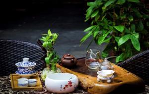 a wooden table topped with vases and other items at 7Days Premium Chendu Kuanzhai Alley Branch in Chengdu