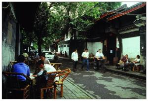 a group of people sitting at tables on a street at 7Days Premium Chendu Kuanzhai Alley Branch in Chengdu