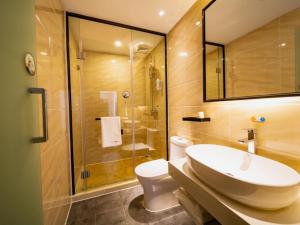 a bathroom with a sink and a toilet and a shower at 7 Days Premium Zhaotong Zhenxiong Branch in Zhenxiong