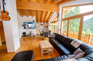 a living room with a couch and a table at Ski Chalet Jim by All in One Apartments in Zell am See