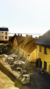 an overhead view of a building with tables and umbrellas at Fästningens in Varberg