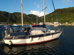 a white sail boat sitting in the water at ATAO Plongee in Les Anses-dʼArlets