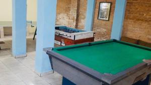 a pool table in the middle of a room at Hotel Planalto in Poços de Caldas