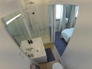 a bathroom with a shower and a sink with a mirror at Le Clos d'Ussé in Rigny-Ussé
