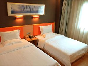 a hotel room with two beds and a window at 7Days Premium Dongguan Dongcheng Subway Station in Dongguan +15 photos