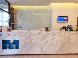 a counter in a store with a white marble counter top at 7Days Premium Beijing Madianqiao North Branch in Beijing