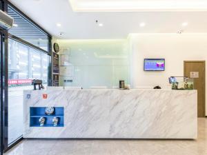 a lobby with a large white counter in a building at 7Days Premium Beijing Madianqiao North Branch in Beijing