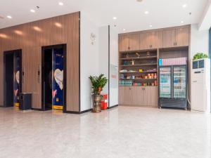 a lobby with two wooden doors and a potted plant at 7Days Premium Zhongshan Tanzhou Town Market Central Branch in Zhongshan