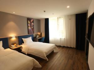 a hotel room with two beds and a window at 7Days Premium Xi'ning Dashizi Center Branch in Xining +21 photos