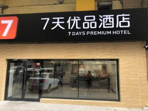 un cartel de un hotel premium con un coche en la ventana en 7Days Premium Anshan Railway Station Pedestrian Street Branch, en Anshan