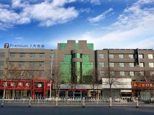 um grande edifício numa rua em frente em 7Days Premium Zhumadian Tianzhongshan Avenue Branch em Zhumadian