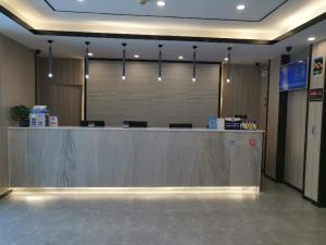 an empty lobby with a reception counter in a building at 7Days Premium Beijing Sanlitun Tuanjiehu Subway Station Branch in Beijing