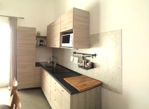 eine Küche mit einer Spüle und einer Mikrowelle in der Unterkunft Il Gabbiano Relais in Stromboli in Stromboli