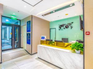 a lobby of an office with a reception desk at 7Days Premium Beijing Zhongguancun Renmin University Suzhou Street Subway Station Branch in Beijing