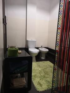 a bathroom with a toilet and a sink at Casa do Ser Hostel in Viana do Castelo