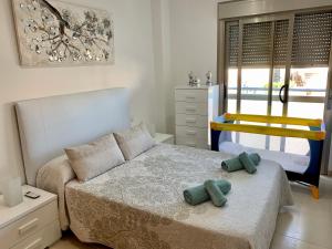 a bedroom with a bed with two pillows on it at Samsara Beach in Port d'Alcudia