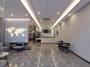 a lobby with a map of the world on a wall at 7Days Premium Dongguan Fenggang Yongsheng Street Branch in Tiantangwei