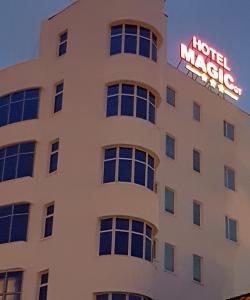 a hotel magic sign on the side of a building at Hotel Magic - City Center in Piteşti