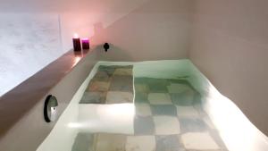 a room with a bath tub with a candle in it at Mediterraneo House in Palermo