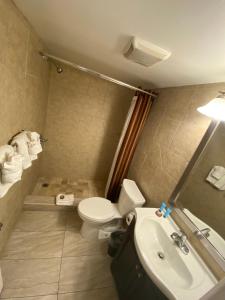 
a bathroom with a sink, toilet and bathtub at Sea Banks Motor Inn in Myrtle Beach
