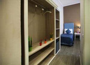 a room with a bed and a dresser in it at Hotel Magenta in Florence