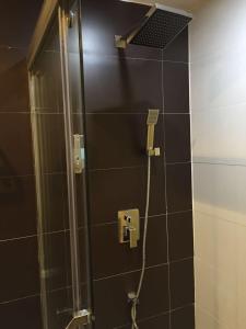 a shower with a glass door in a bathroom at 7Days Inn Dao County Xiaoshui Middle Road No.2 Middle School Branch in Daojiang