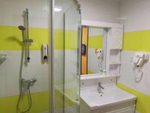 a bathroom with a shower and a sink at 7Days Inn Danyang Train Station Wuyue Square Branch in Zhenjiang