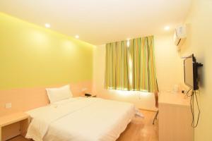Un pat sau paturi într-o cameră la 7Days Inn Luoyang Xin'an Branch