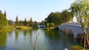 a bridge over a river in a park at 7Days Inn Nanjing Gulou Yunnan Road Metro Station Branch in Nanjing