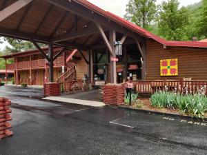 a building with a flag on the front of it at Smoky Falls Lodge in Maggie Valley
