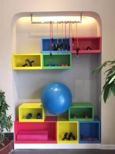 a play room with colorful shelves and a blue ball at 7Days Inn Bojin Shui'an Linchuan No.3 School in Fuzhou