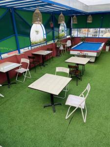 a room with tables and chairs and a ping pong table at Poetic Hue Hotel & Spa in Hue +49 photos