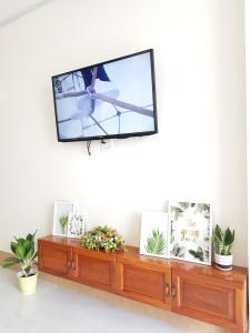 a flat screen tv on top of a wooden entertainment center at Quyen's house in Can Tho +19 photos