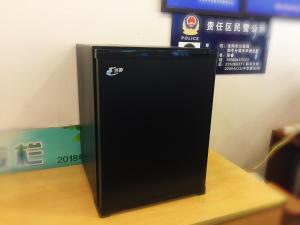 沈阳7天酒店· 沈阳火车站中山广场店的一张桌子上的一个黑色警用冰箱