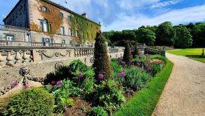 a garden with flowers in front of a building at The Waterside Townhouse in Mayo