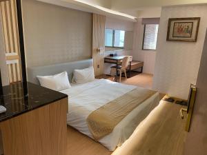 Ένα ή περισσότερα κρεβάτια σε δωμάτιο στο Wang Fu Hotel