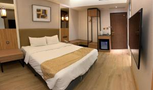 Ένα ή περισσότερα κρεβάτια σε δωμάτιο στο Wang Fu Hotel