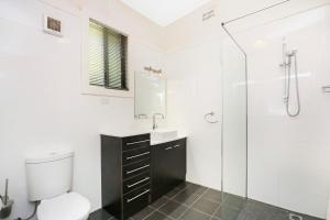
a bathroom with a toilet, sink, and shower stall at Townhouse 3 in Broken Hill
