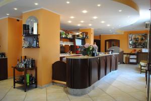 a bar in a restaurant with flowers on the counter at Hotel Cigno Reale in Rolo