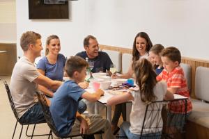 a group of people sitting around a table eating at BIG4 West Beach Parks in Adelaide