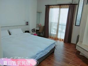 Postel nebo postele na pokoji v ubytování Penghu Summer Aroma Homestay