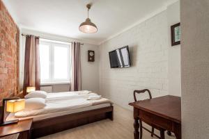 斯维德尼克艾维昂公寓式酒店的一间卧室，里面有一张床、一张桌子和一扇窗户。