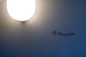 a light on a wall with the words do camerana on it at La Canarina Bed & Breakfast in Como