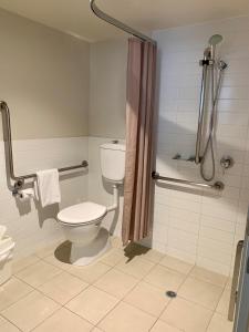 a bathroom with a toilet and a shower at Quest Chermside in Brisbane