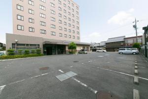 an empty parking lot in front of a building at Iga Ueno City Hotel in Iga