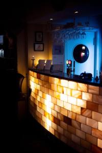 a bar with a brick wall with lights on it at Lilla Hotellet in Vilhelmina +16 photos