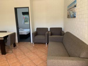 a waiting room with couches and a table and a mirror at Harbour Side Resort in Gold Coast