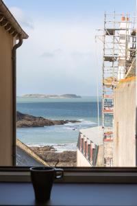 a view of the ocean from a window at Cap à l'Ouest by Cocoonr in Saint Malo
