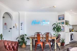 a dining room with a table and chairs at Oh My Beach View - Top Floor Paradise by Sydney Dreams Serviced Apartment Bondi in Sydney